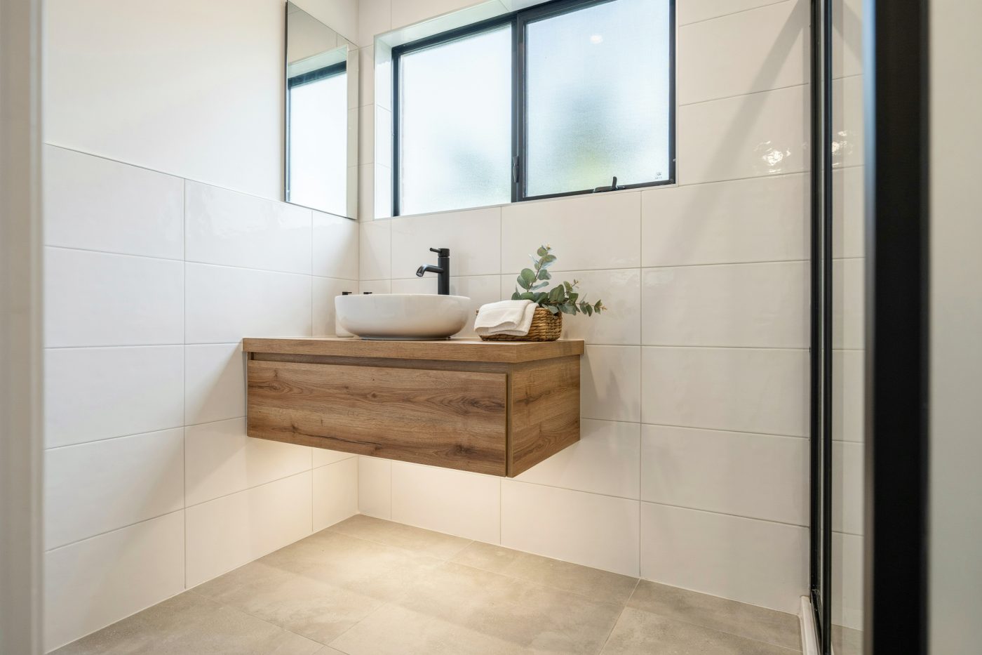 Completed contemporary bathroom renovation with matte black tapware