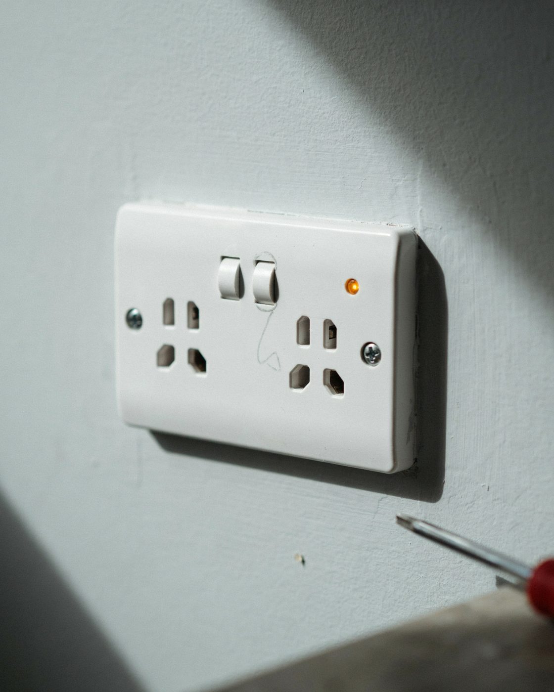 Freshly installed double power point on a light grey wall